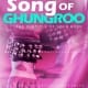 Premade book cover design for “The Song of Ghungroo” featuring a close-up of a dancer’s feet with traditional ankle bells (ghungroos), set against a vibrant pink and purple background with bold turquoise and white typography.